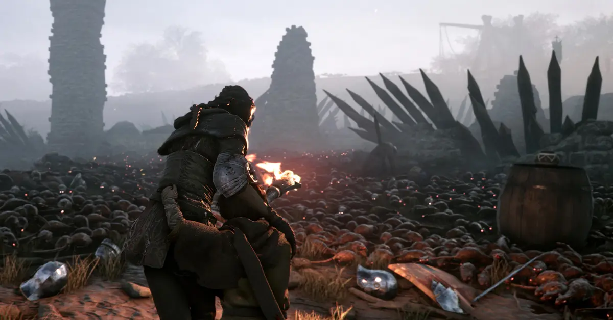 Amicia die een fakkel gebruikt om rattenschermen af te weren in A Plague Tale Innocence