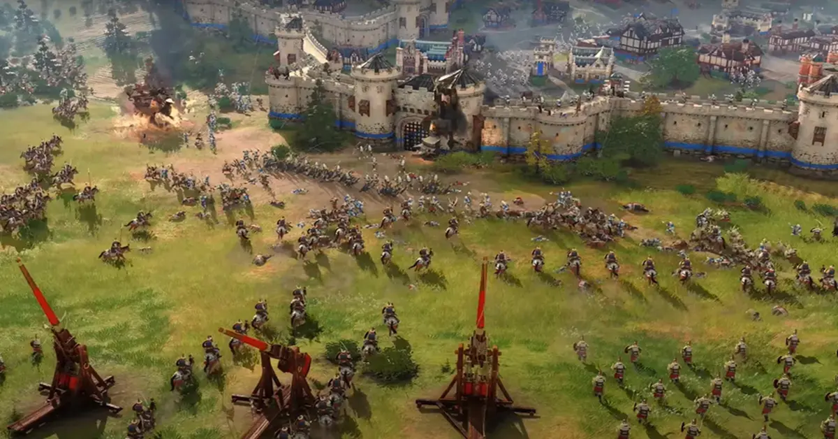 In-game screenshot van Age of Empires IV met een grootschalige middeleeuwse belegering met trebuchets en cavalerie-eenheden