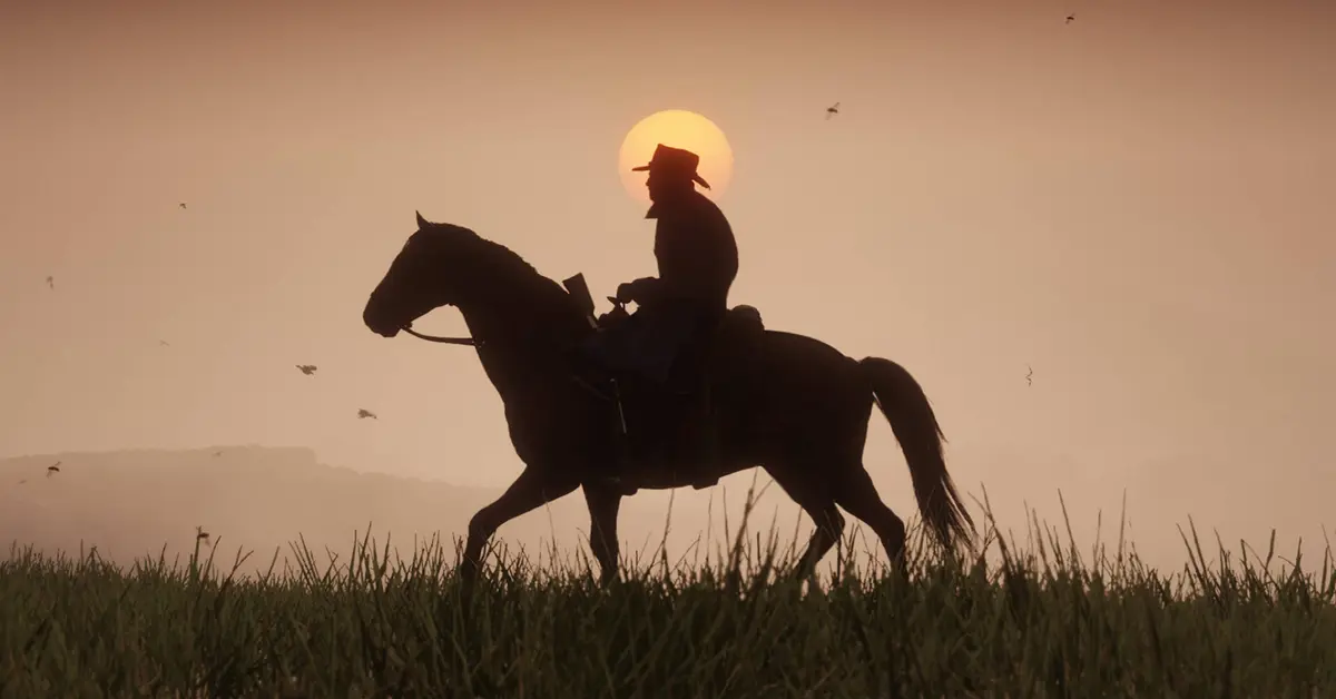 Arthur Morgan te paard tijdens een zonsondergang in Red Dead Redemption 2.